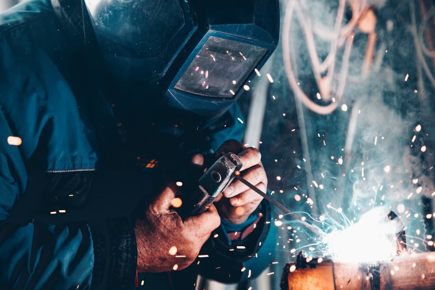 Technician welding a steel section during an installation and maintenance activity