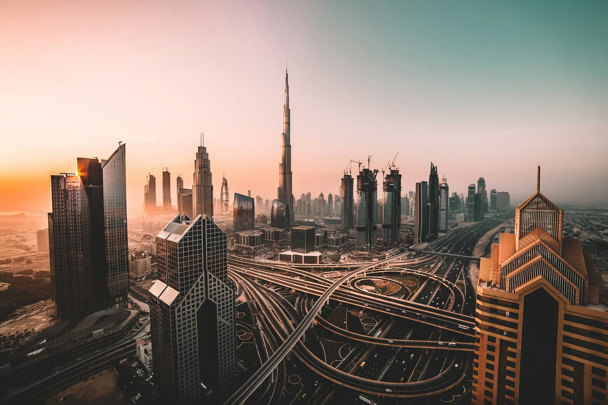 Dubai skyline at dawn, with commercial towers and infrastructure across the city